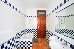 a bathroom with black and white checkered tiles at SATURdAYS in Lisbon