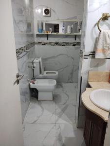 un baño con inodoro y lavabo en Casa Quinta con pileta Tortuguitas Bs As, en Manuel Alberti
