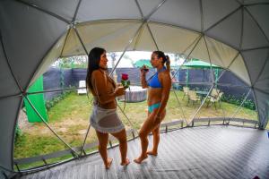 two women standing inside of a tent at Paraiso Tropical Glamping in San Antonio