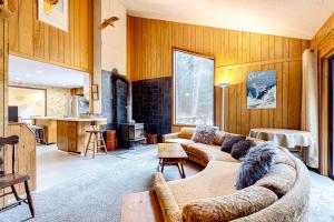 a living room with two couches and a kitchen at Rustic Escape in Franconia