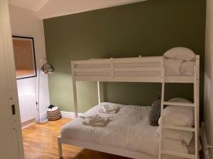 a bunk bed in a room with a green wall at The Lofthouse in Blackpool