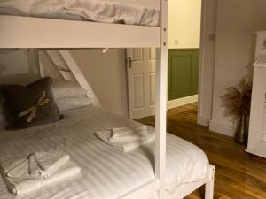 a white bunk bed with towels on top of it at The Lofthouse in Blackpool