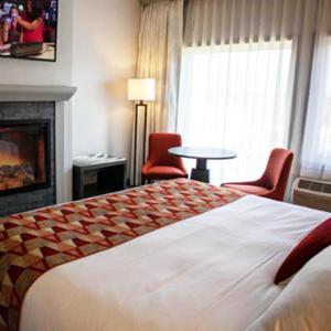 a hotel room with a large bed and a fireplace at Quinault Beach Resort & Casino in Ocean Shores