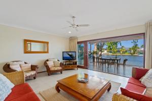 a living room with a couch and a table at Noosa Entrance Waterfront Resort in Noosaville