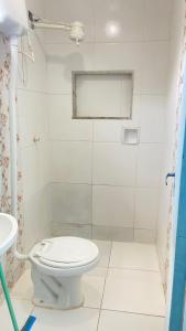 a bathroom with a toilet and a shower at Antonia Hospedaria 2 in Búzios
