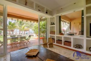 an open living room with a dining room and patio at Chac Hal, Beachfront Apartment with Amenities - Chac Hal 2 in Puerto Aventuras