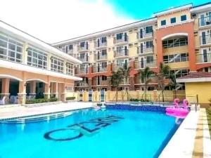 a large swimming pool in front of a building at Arezzo Place Condo in Davao City