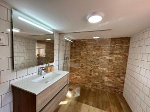 a bathroom with a sink and a mirror at Casa d'avó Coragem in Seia