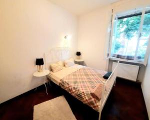 a bedroom with a bed with a table and a window at Old Town Central 2 Bedroom Oasis in Timişoara