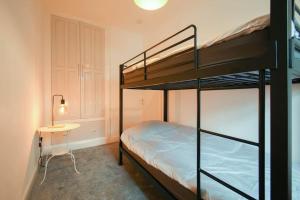 a bedroom with two bunk beds and a table at Home in the Heart of Accrington in Church