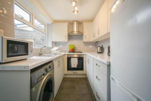 a kitchen with a washing machine and a sink at Home in the Heart of Accrington in Church