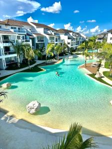 a swimming pool in front of some apartment buildings at Estrella Dominicus Advantage in Bayahibe