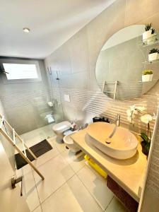 a bathroom with a sink and a toilet and a mirror at Estrella Dominicus Advantage in Bayahibe