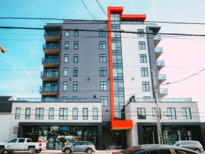 a large building with cars parked in front of it at NEW Luxury 1BR Penthouse Apt In Central Halifax in Halifax