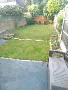 a backyard with a lawn and a yard with a fence at Walthamstow 1 bed in London