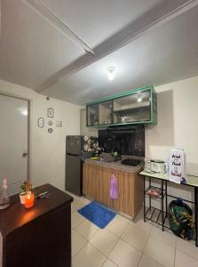 a kitchen with a refrigerator and a counter top at Kachada Condotel Urban Deca Home in Manila