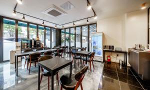 a restaurant with tables and chairs and a kitchen at G7 Hotel in Dongducheon