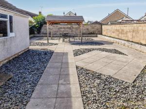 a patio with a table and a gazebo at Gwynfa in Rhyl