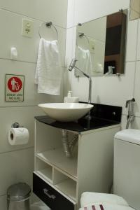 a bathroom with a sink and a mirror at Recanto da Sol in Belo Horizonte
