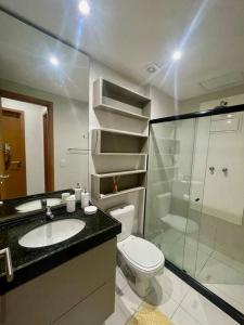 a bathroom with a toilet and a sink and a shower at Muro Alto - Flat Completo MANA Resort in Porto De Galinhas