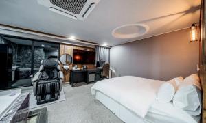 sypialnia z łóżkiem, biurkiem i telewizorem w obiekcie G7 Hotel w mieście Tongduch'ŏn