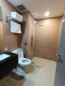 a bathroom with a toilet and a shower and a sink at ēRYA by SURIA Hot Spring Bentong in Bentong