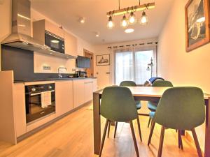 a kitchen and dining room with a table and chairs at Appartement Morzine, 2 pièces, 4 personnes - FR-1-524-118 in Morzine
