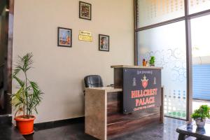 a cashier counter in a room with plants at HILLCREST PALACE in Udaipur