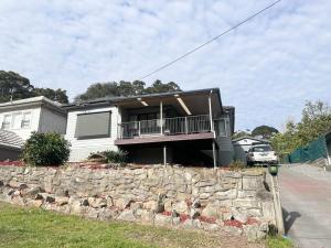 a house with a stone wall in front of it at Charlestown Central 5 Bedrooms Front House in Charlestown +21 photos