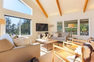 a living room with two couches and a tv at Trinity By Palm House Hospitality Stays in Glen Ellen