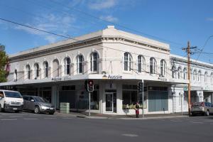 a white building on the corner of a street at The Banker's Loft - Central Launceston Art Deco Pad in Launceston