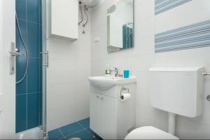 a bathroom with a toilet and a sink and a shower at Studio Stella in Rovinj +29 photos