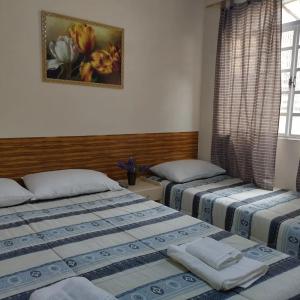 Ένα ή περισσότερα κρεβάτια σε δωμάτιο στο Pousada Linda Borboleta