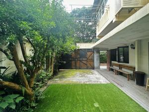 a courtyard with a bench and a green lawn at Shanghai Lane 里弄公寓 in Shanghai