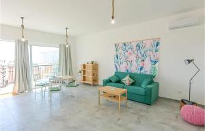 a living room with a green couch and a table at 1 Bedroom Nice Apartment In Marzamemi in Marzamemi +10 photos