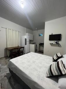 a bedroom with a large bed and a table at APARTAMENTO MOBILIADO in Boa Vista