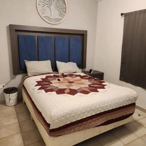 a bedroom with a large bed with a quilt on it at 3 bedroom townhouse w garage blocks from the beach in Puerto Peñasco