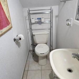 a small bathroom with a toilet and a sink at 3 bedroom townhouse w garage blocks from the beach in Puerto Peñasco