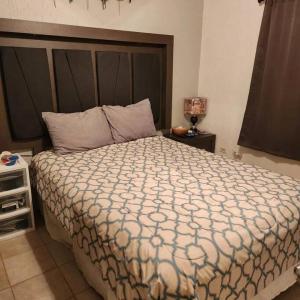 a bedroom with a large bed with a large headboard at 3 bedroom townhouse w garage blocks from the beach in Puerto Peñasco
