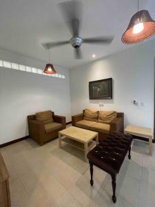 a living room with couches and a ceiling fan at Cozy 1 Bedroom Condo w Balcony in Shah Alam