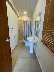 a bathroom with a sink and a toilet at Cozy 1 Bedroom Condo w Balcony in Shah Alam