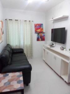 a living room with a couch and a flat screen tv at Camella Manor Majorca 7A in Bacolod +8 photos