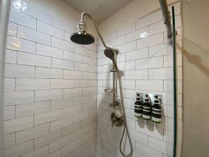 a shower with a shower head in a bathroom at Orange You Glad you came in Miami