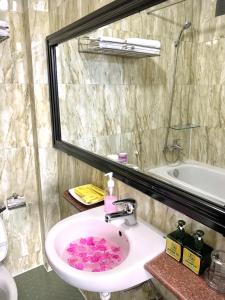 a bathroom with a sink with pink hearts on it at Jade Hotel in Hue