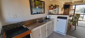 a kitchen with a sink and a counter top at Waterfalls Estate - Falls Motel & Waterfront Campground in Paihia