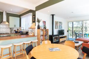 a kitchen and living room with a table and chairs at Katoomba Falls Cottage in Katoomba