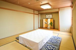 a room with a white table in a room at Hotel Marroad Tsukuba in Tsuchiura