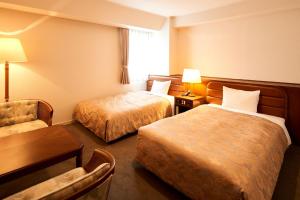 Postel nebo postele na pokoji v ubytování Hotel Marroad Tsukuba