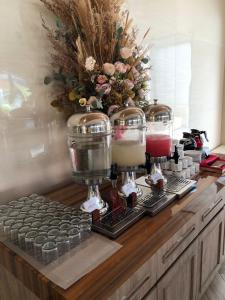 a coffee machine sitting on a wooden counter with drinks at One of A Kind Resort @Trikora Beach - Bintan 
