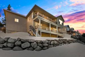 a house on the beach with a stone wall at Upscale Huge Home 2 Decks w Views 2 Living Rooms in Spokane